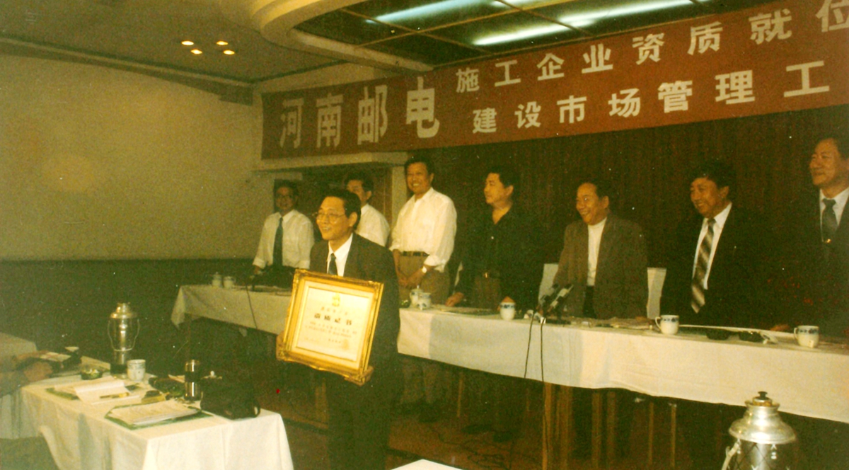 1995年由河南省邮电管理局局长楚俊国主持的通信施工企业资质颁发大会上，我公司是唯一一家获得一级资质的企业，图为局长赵森林接受资质颁发.jpg